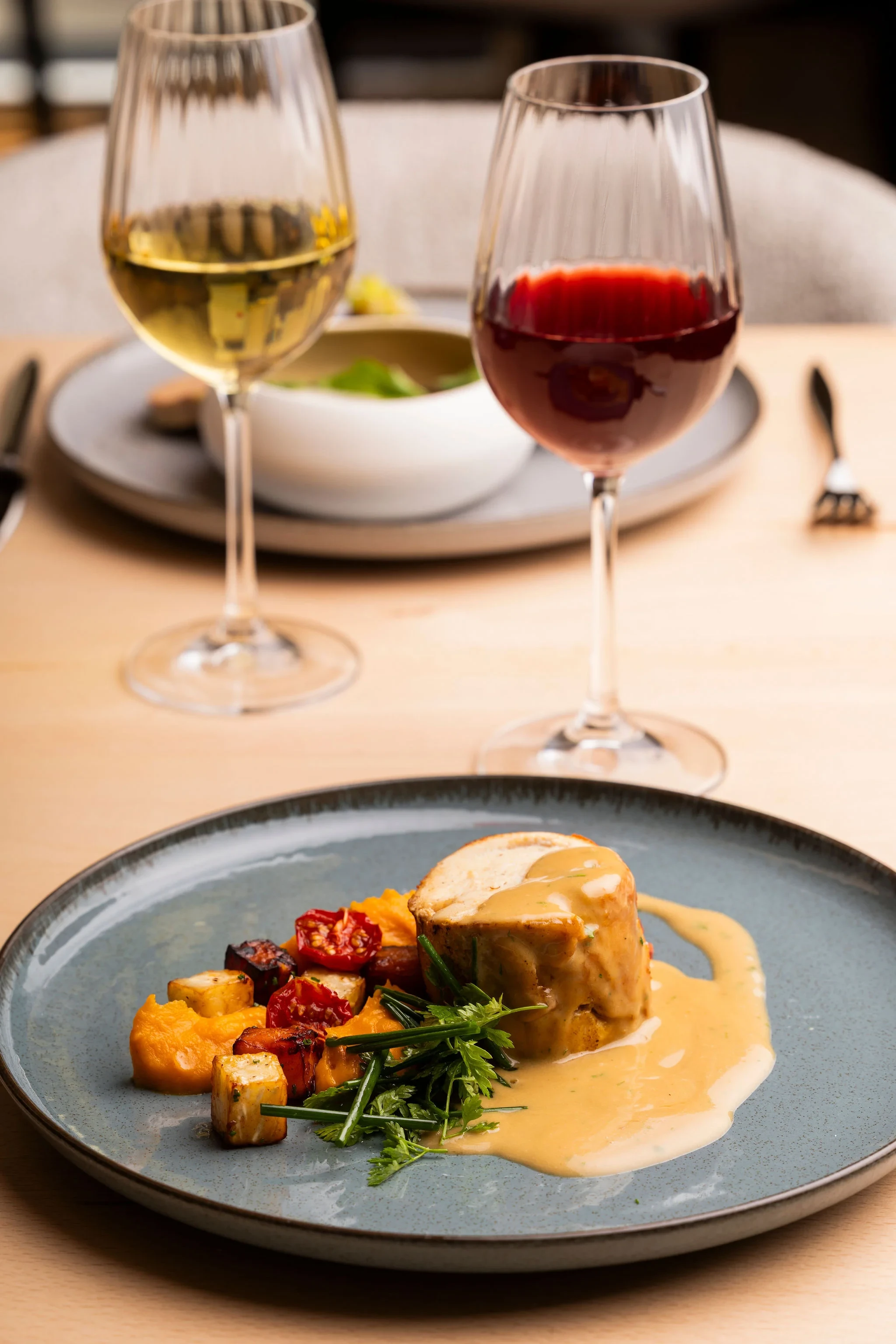 Plat gastronomique avec vins rouge et blanc