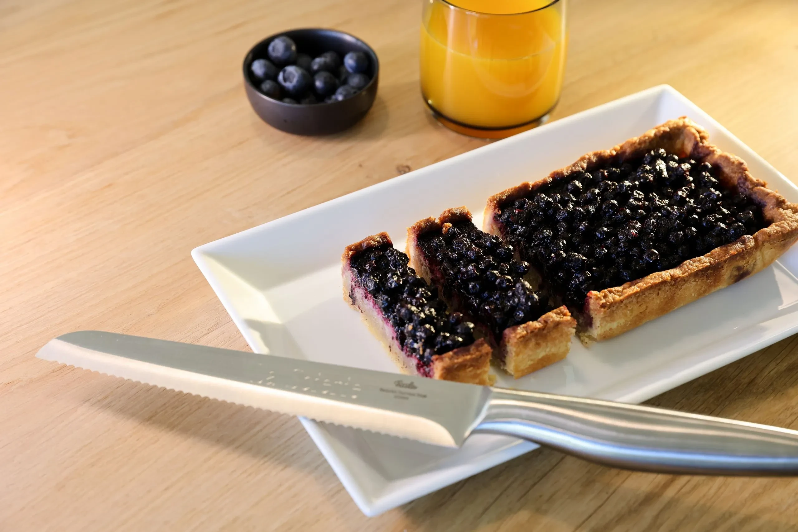 Tarte aux myrtilles et jus d’orange sur table - Séjour Jura - Domaine La Scierie